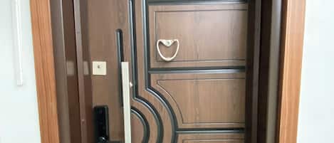A wooden door with a handle, a lock, and a keyhole.