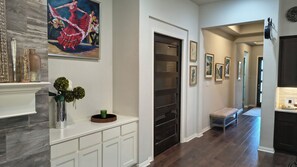 A hallway with a fireplace, a painting, and a bench. - Serene 3-bedroom house. Less than 5 minutes to restaurants and entertainment. (Georgetown)