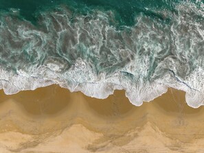 A beach with waves crashing onto the shore. - Ventana al Paraíso Oceanfront Villa (Bajos de Chila)