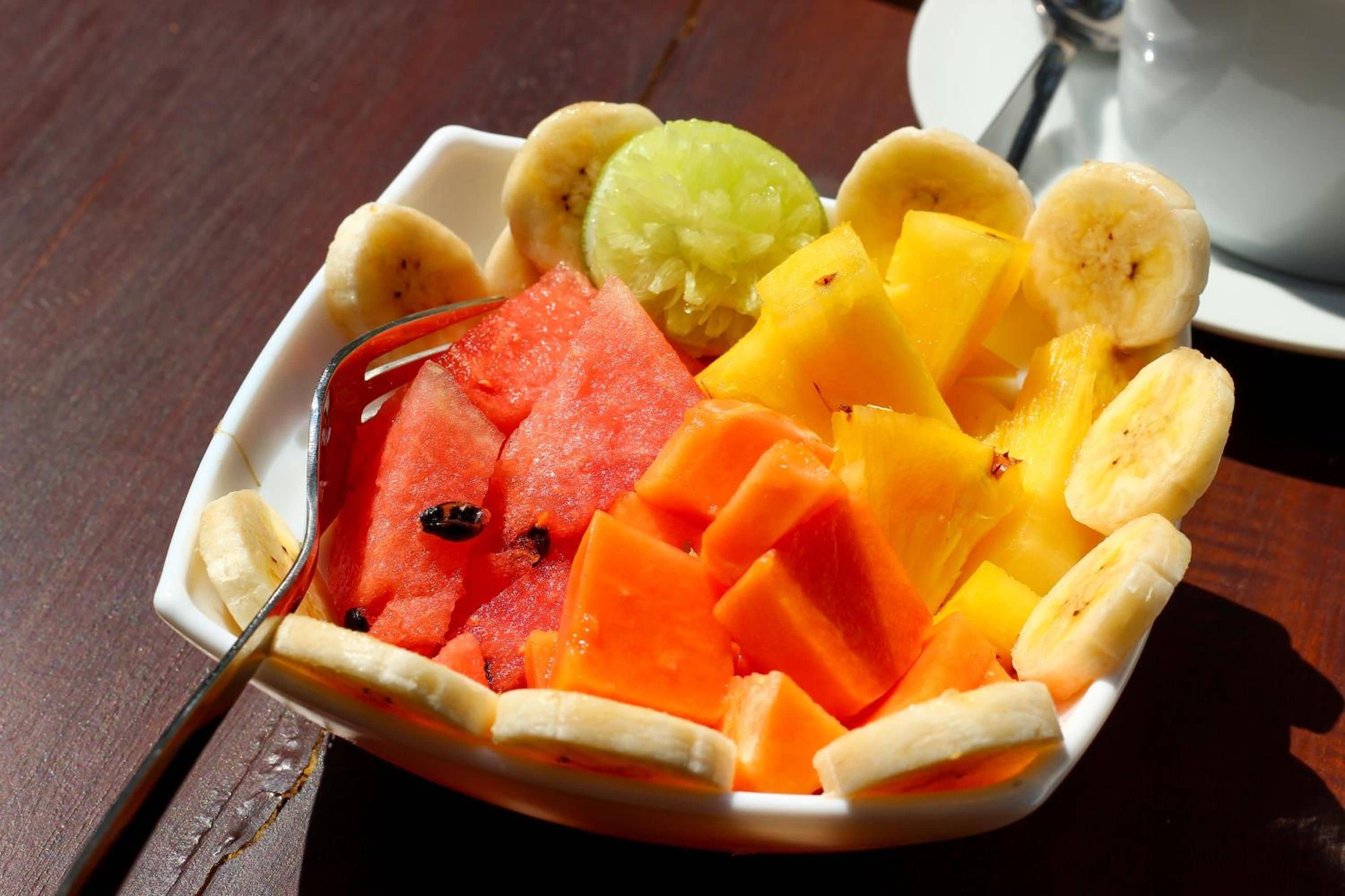 A bowl of assorted fruits including watermelon, pineapple, and bananas.