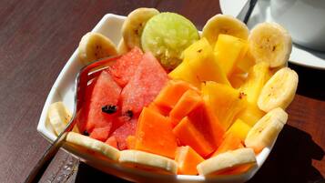 A bowl of assorted fruits including watermelon, pineapple, and bananas.