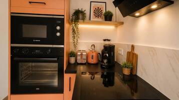 A kitchen with a Bosch oven, a coffee maker, and a toaster.