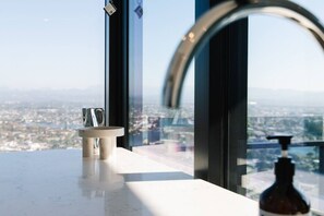 A bathroom with a large window, a sink, and a bottle of soap. - Luxury 2BR with Panoramic Gold Coast Views (Broadbeach)