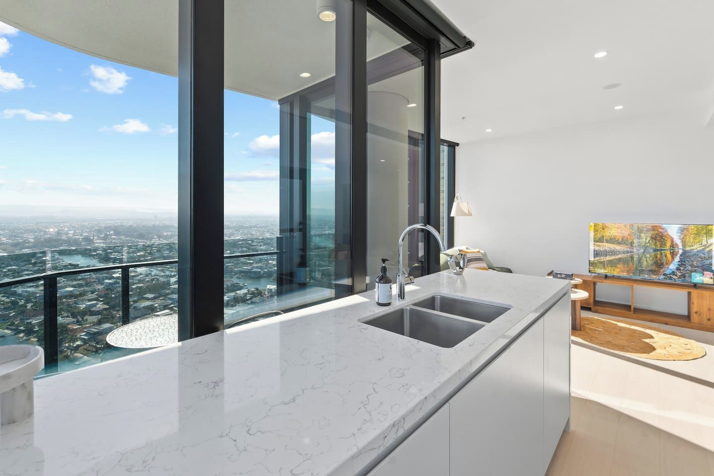 A modern kitchen with a large window and a city view.