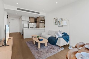 A modern apartment with a living area, kitchenette, and dining space. - Luxe 1BR Island Getaway in Broadbeach (Broadbeach)