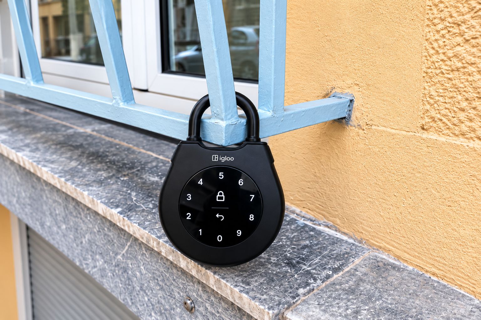 A black electronic lock attached to a window frame.