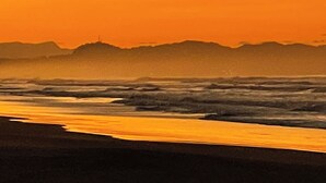 A beach scene with waves and a distant hill. - AC, Wi-Fi & Pool - Beachfront Palo Seco (Parrita)