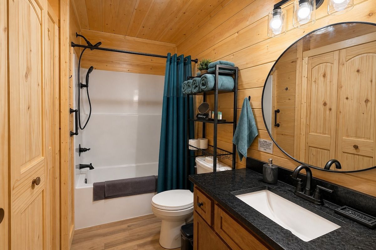 A compact bathroom with a bathtub, toilet, sink, and a mirror.