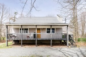 A two-story house with a porch, a front door, and a small staircase leading to the entrance. - The Pine Haven - 8 Min to Kalahari - Hot Tub & Fire Pit (Long Pond)