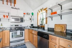 A modern kitchen with wooden cabinets, a stainless steel oven, a dishwasher, and a microwave. - The Pine Haven - 8 Min to Kalahari - Hot Tub & Fire Pit (Long Pond)