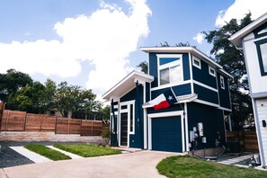A two-story house with a garage, a flag, and a well-maintained lawn. - Newly remodeled 2br/2ba on South First! OleMiss + F1! (Austin)