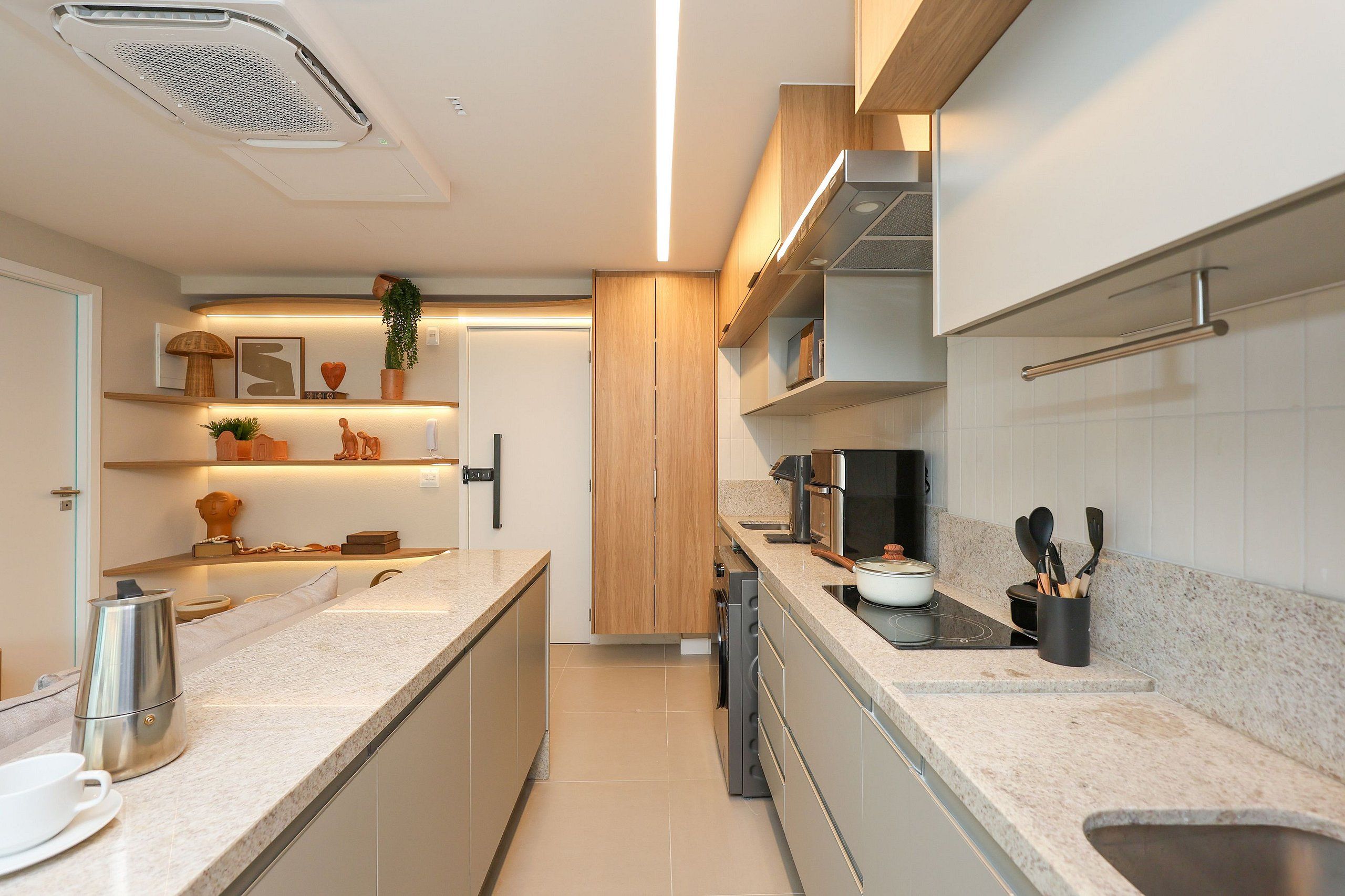 A modern kitchen with a central island, built-in appliances, and a variety of storage options.