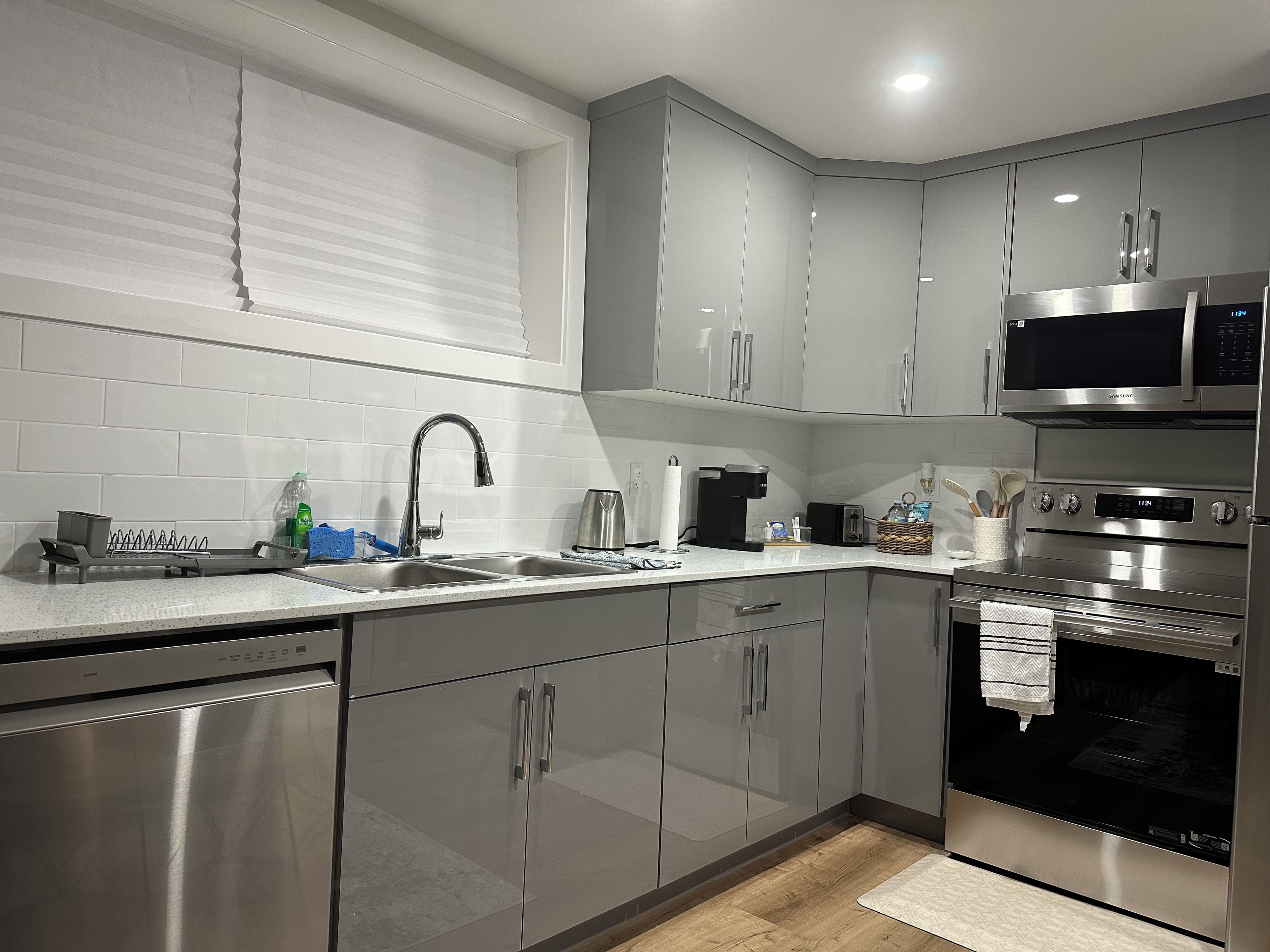 A modern kitchen with stainless steel appliances, a built-in microwave, and a coffee maker.
