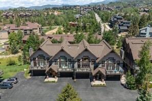 A multi-story building with a central courtyard, surrounded by trees and other buildings. - Ski, Hike, Soak: The Alpine Escape Awaits (Steamboat Springs)