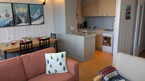 A compact living space with a dining area, kitchenette, and a sofa with a patterned cushion. - 100m from ski lifts, 2nd floor, balcony, tv, ski locker, 55m², Orcières Merlette 1850 (Orcières)