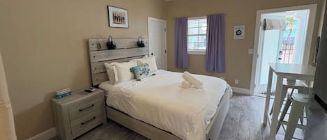 A bedroom with a bed, nightstand, and a ceiling fan.