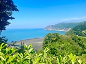 A coastal landscape with a beach, cliffs, and dense greenery. - Sea-Renity Sidmouth Sleeps 6 Parking for 2 Vehicles (Sidmouth)