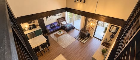 Un amplio espacio de sala con chimenea, un sofá y una mesa de comedor.