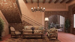 A cozy living room with a sofa, armchairs, a coffee table, and a chandelier. - Aria Santa María (Santo Domingo)