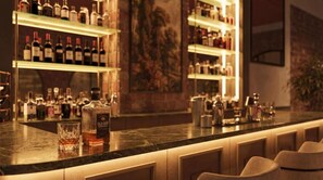 A bar area with shelves of bottles, a glass, and a bottle of Old Grandfather whisky. - Aria Santa María (Santo Domingo)