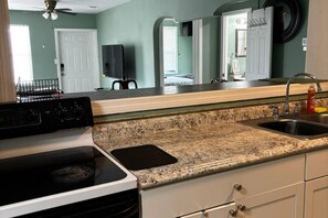 A kitchen with a stove, oven, granite countertop, and a sink. - Downtown Sarasota House 3br,2ba, Pet-friendly,6ppl (Sarasota)
