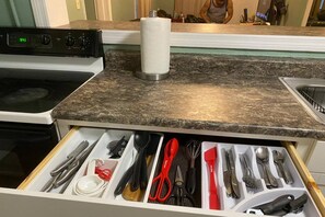 A kitchen with a stove, a countertop, and a drawer organizer with utensils. - Downtown Sarasota House 3br,2ba, Pet-friendly,6ppl (Sarasota)
