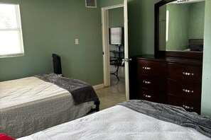 A bedroom with two beds, a dresser, and a mirror. - Downtown Sarasota House 3br,2ba, Pet-friendly,6ppl (Sarasota)
