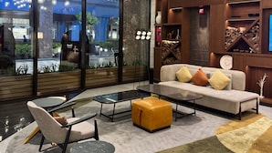 A modern interior with a sofa, chairs, a coffee table, and hanging lights. - Dec 2 Hotel (Bouvet Island)