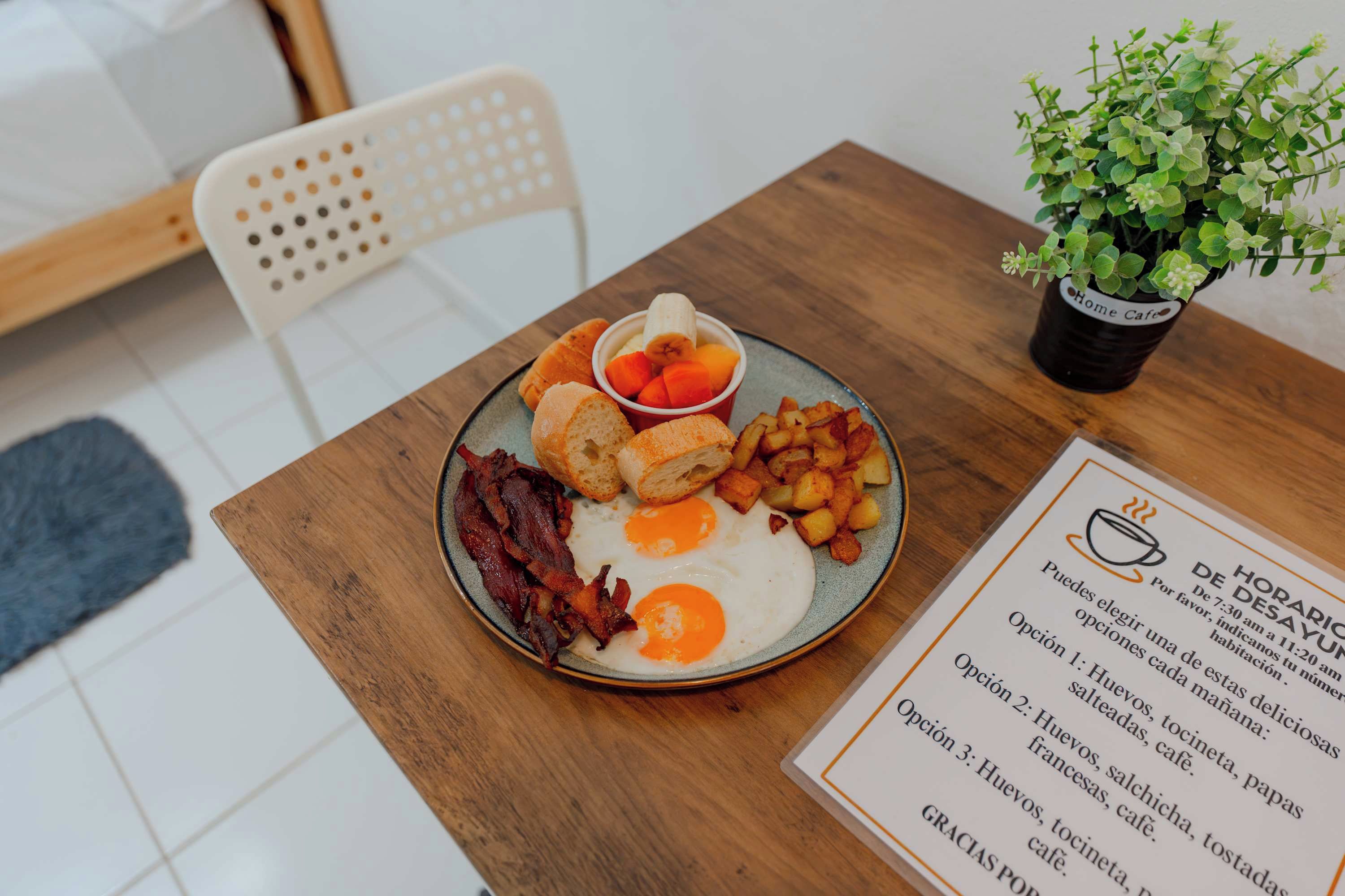 A breakfast plate with eggs, bacon, toast, and potatoes.