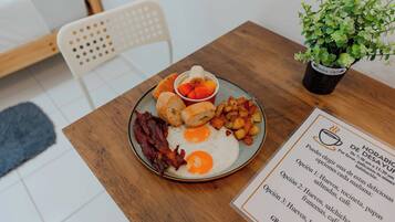 A breakfast plate with eggs, bacon, toast, and potatoes.