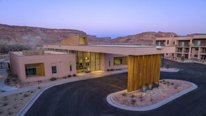 A modern hotel with a flat roof, large windows, and a central courtyard.