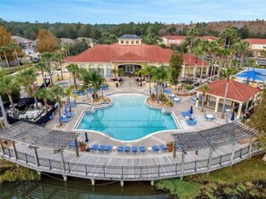 A resort with a central pool, lounge areas, and a covered deck. - 3 BD/ 2.5 BA/ Terra Verde (4709 FB) (Kissimmee)