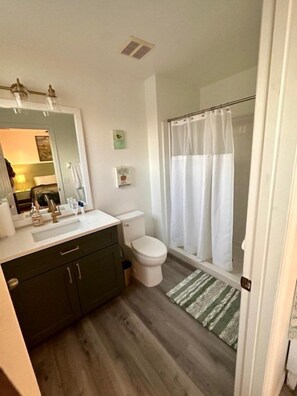 A bathroom with a toilet, sink, and shower area. - 3 BD/ 2.5 BA/ Terra Verde (4709 FB) (Kissimmee)