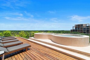 A rooftop terrace with a hot tub, wooden deck, and lounge chairs. - Sáasil: Tranquil Oasis w/ Golf course views (Playa del Carmen)