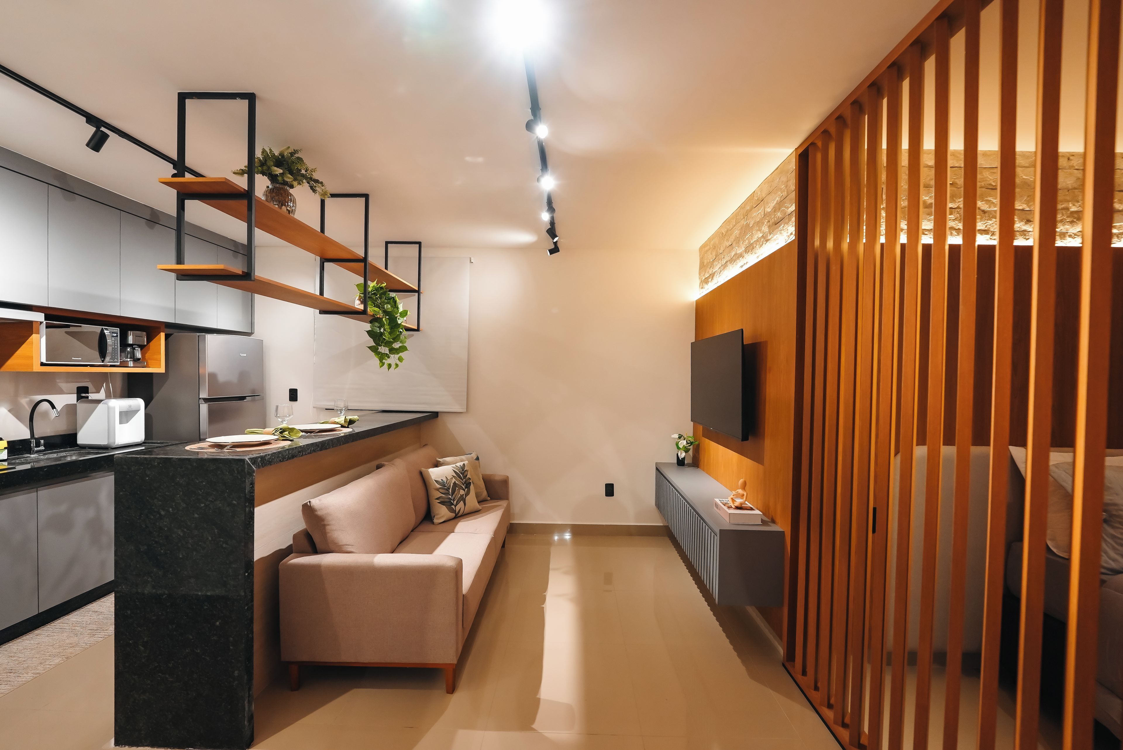 A modern kitchen with a built-in microwave, toaster, and coffee maker.