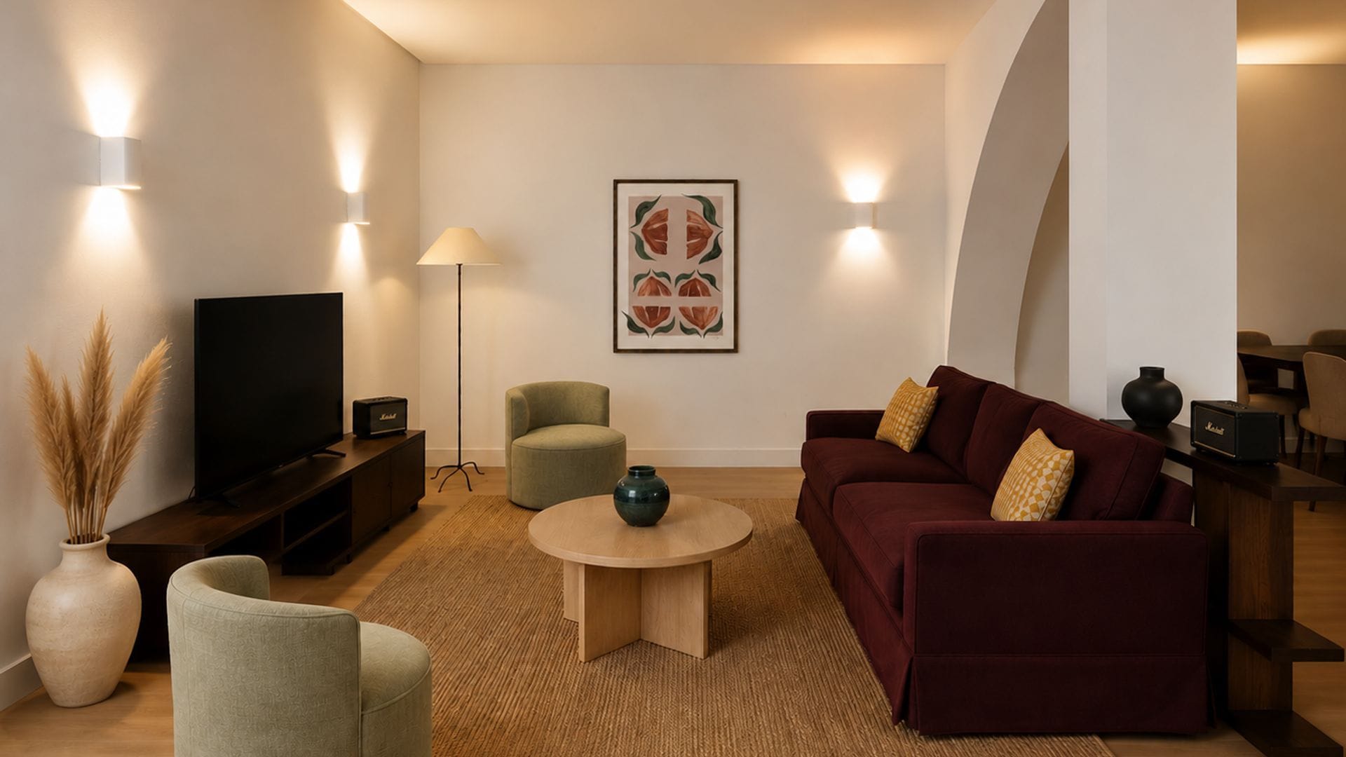 A modern living room with a flat-screen TV, a sofa, a coffee table, and a lamp.
