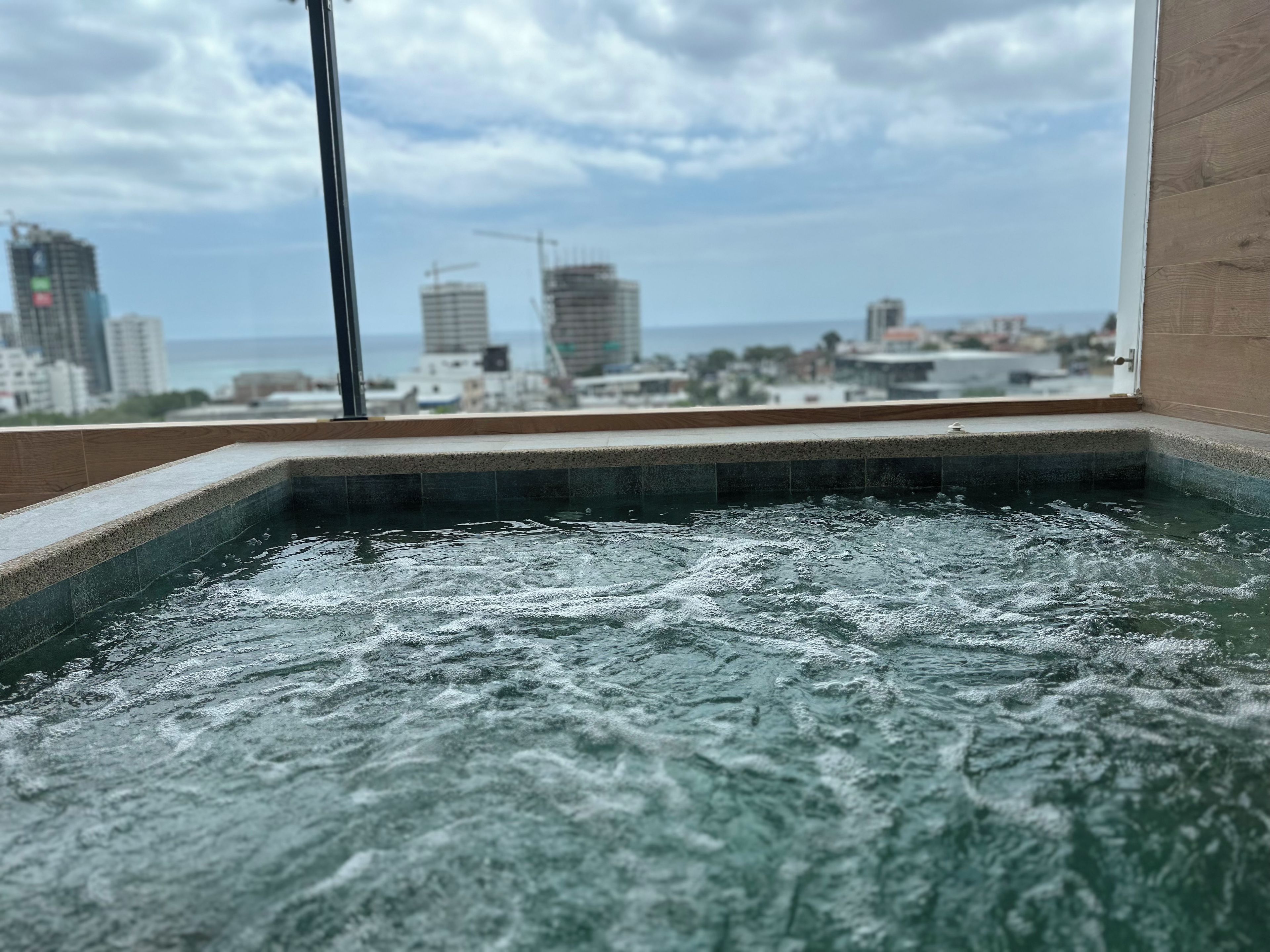 A hot tub with a cityscape view.