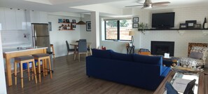 A modern living space with a kitchen, dining area, and seating area.