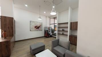 A modern interior with a sofa, a small table, and a decorative wall piece.