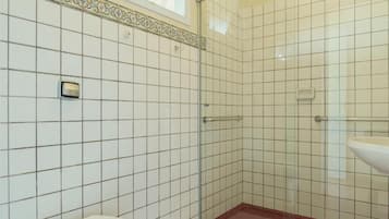A bathroom with a shower, toilet, and sink.