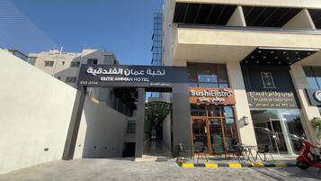 Esterno dell'Hotel Elite Amman, con l'ingresso e la segnaletica del Sushi Bistro ben visibili.