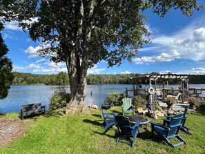 A lakeside deck with outdoor seating, a pergola, and a fire pit. - Lake Onderdonk Retreat - Lakefront + Fall Foliage (Berne)