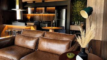 A modern living room with a leather sofa, a round wooden table, and a minimalist decor.