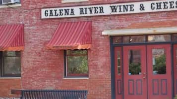 A brick building with a sign reading 'Galena River Wine & Cheese.'