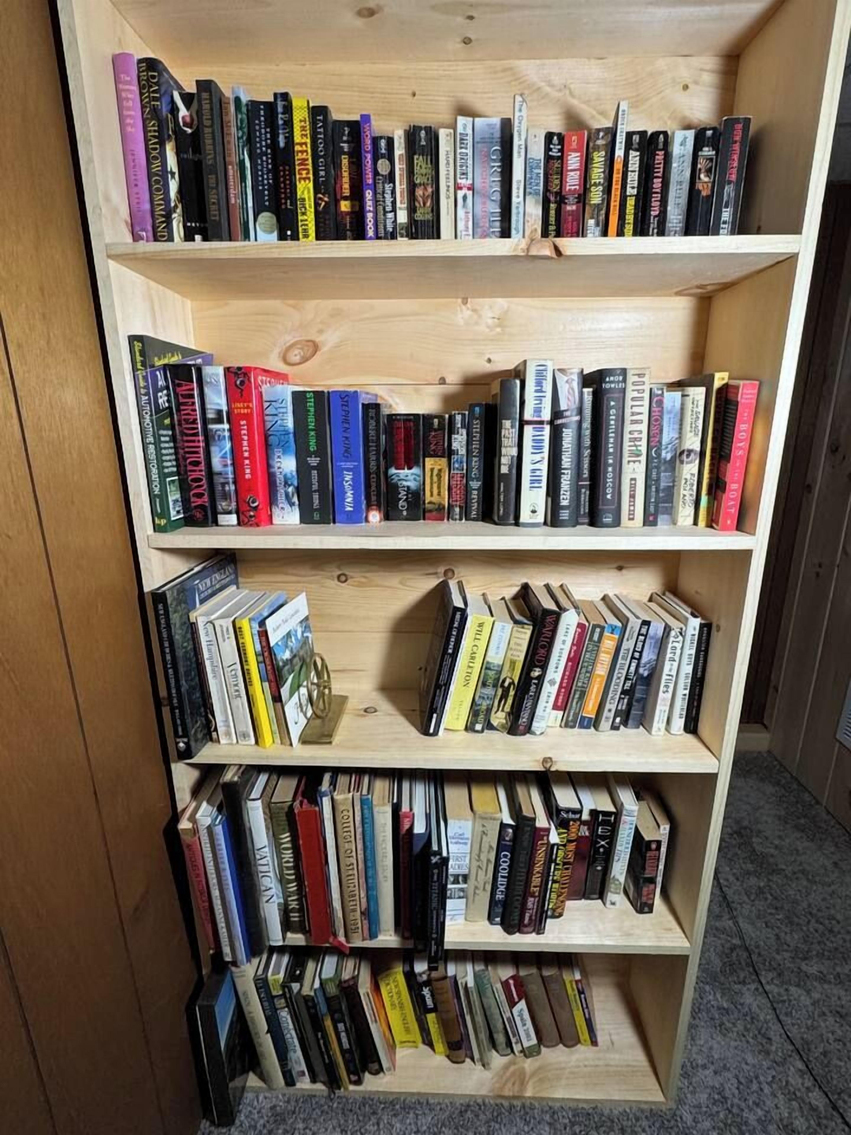 A bookshelf with multiple shelves filled with books.