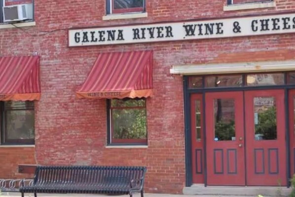 A brick building with a sign reading 'Galena River Wine & Cheese.'