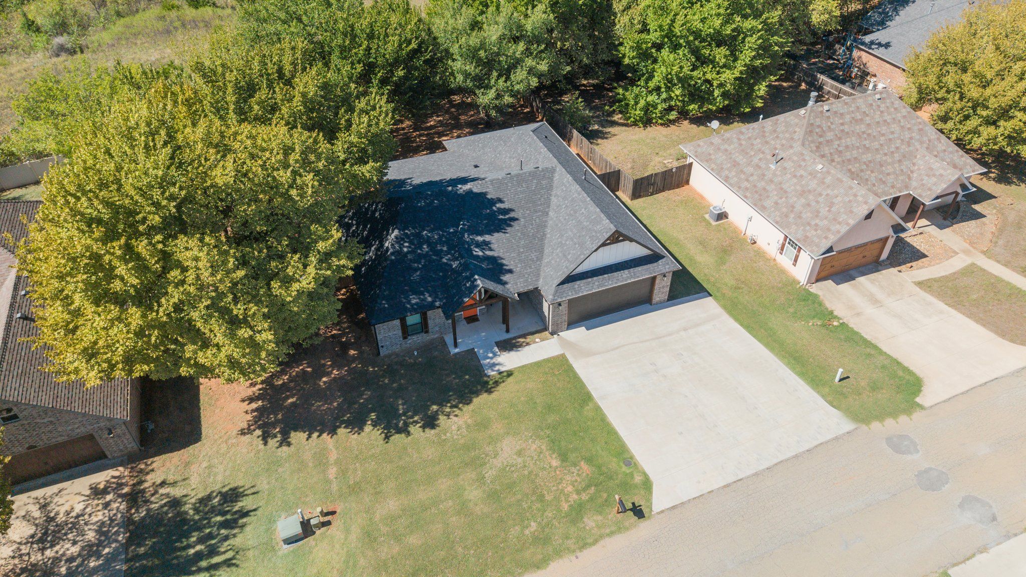 A residential property with a garage, a covered patio, and a lawn.
