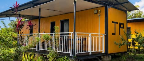 A yellow building with a covered porch and a 'JP' sign.