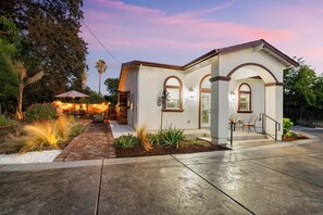 A two-story house with a patio, outdoor seating, and a garden. - Newly Constructed 1-bedroom guest house near Arden Park (Sacramento)