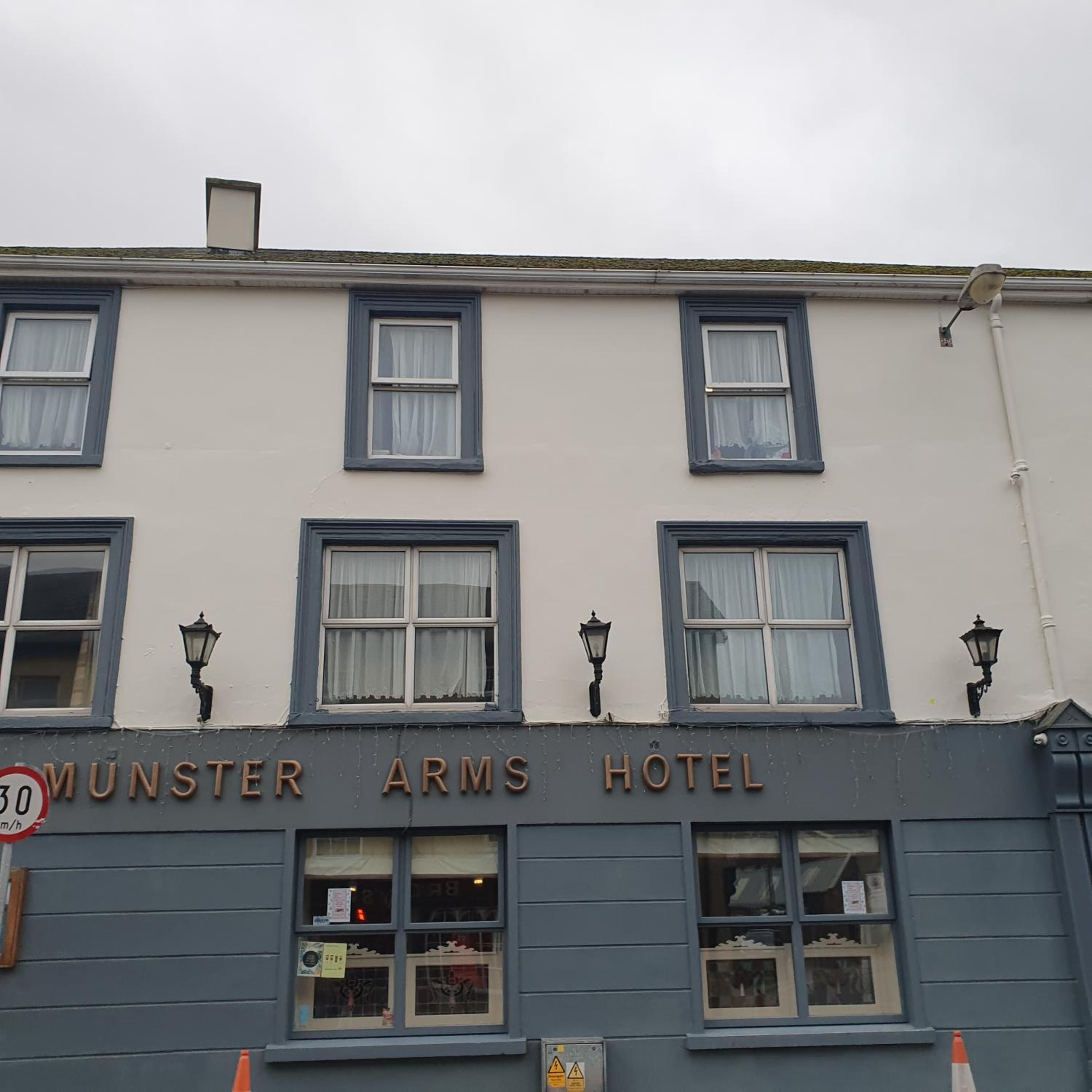 A building with a sign reading 'Munster Arms Hotel'.